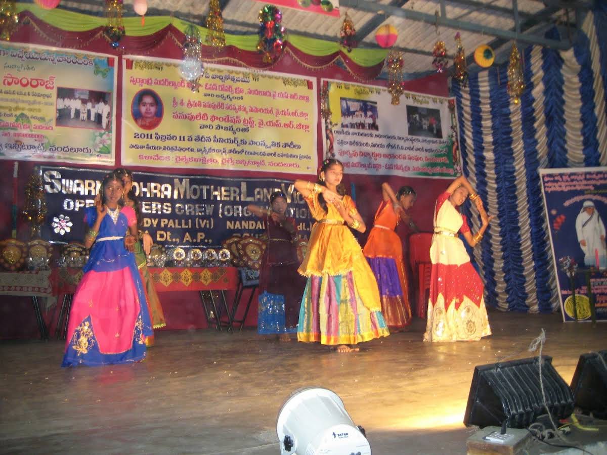 Girls in traditional langa voni performing a group dance on the decorated annual-day stage
